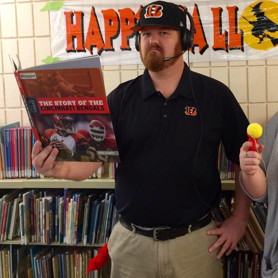 Mr. Jack holding a book on the Cincinnati Bengals.